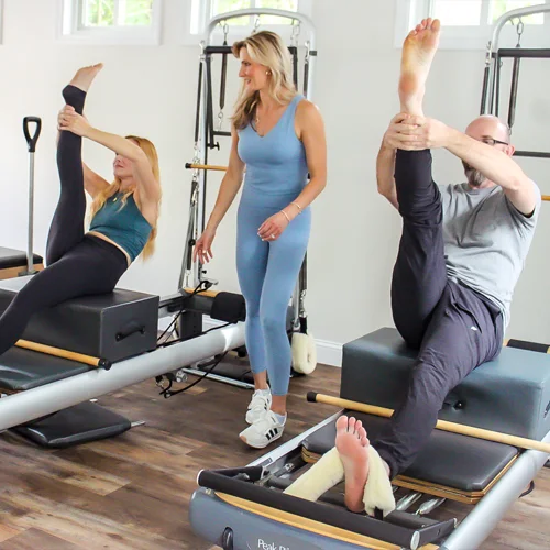 Pilates Burlington MA Nicole Burns With Clients In Tree Pose